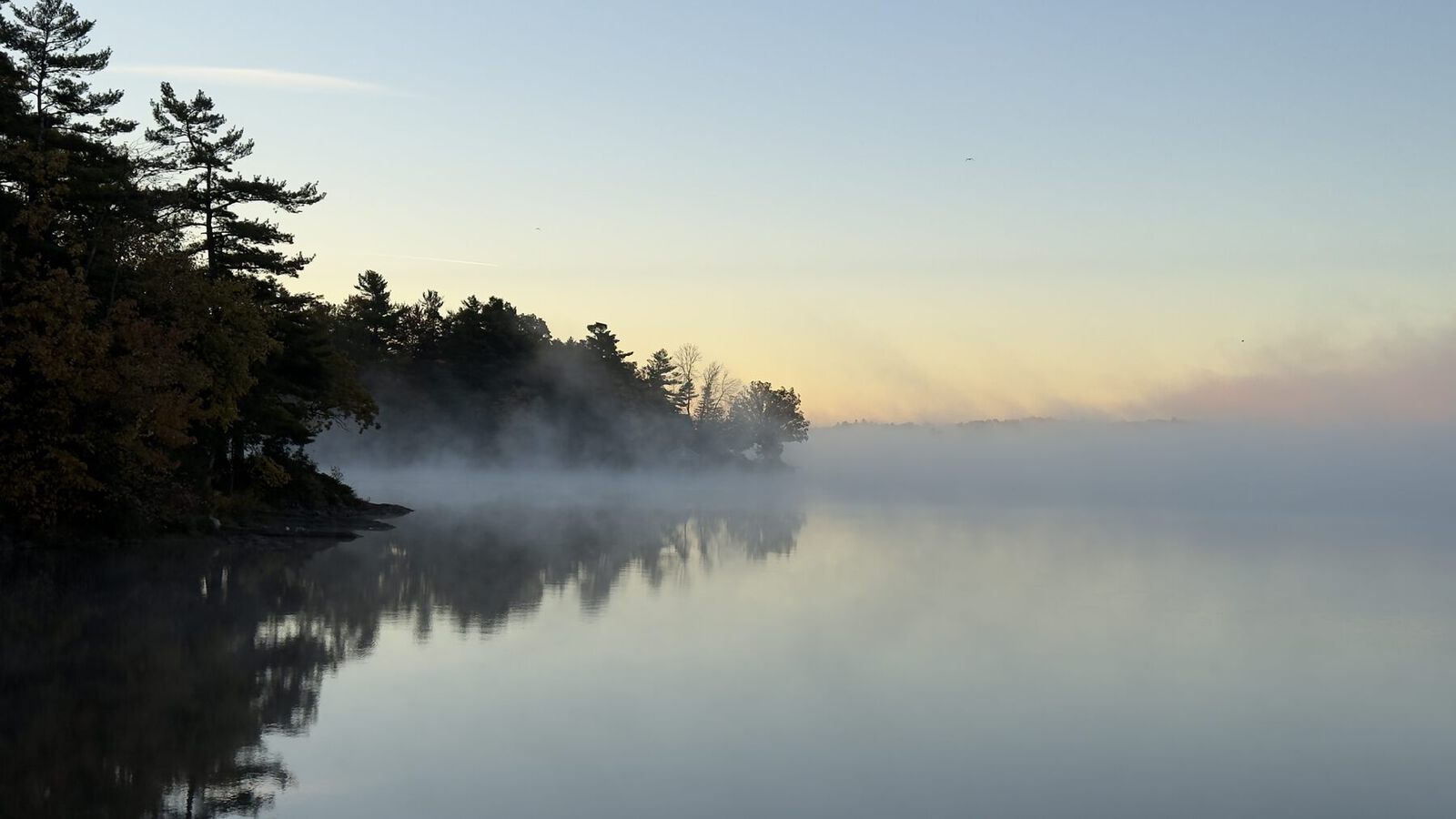 Morning mist on the water in Rideau Lakes